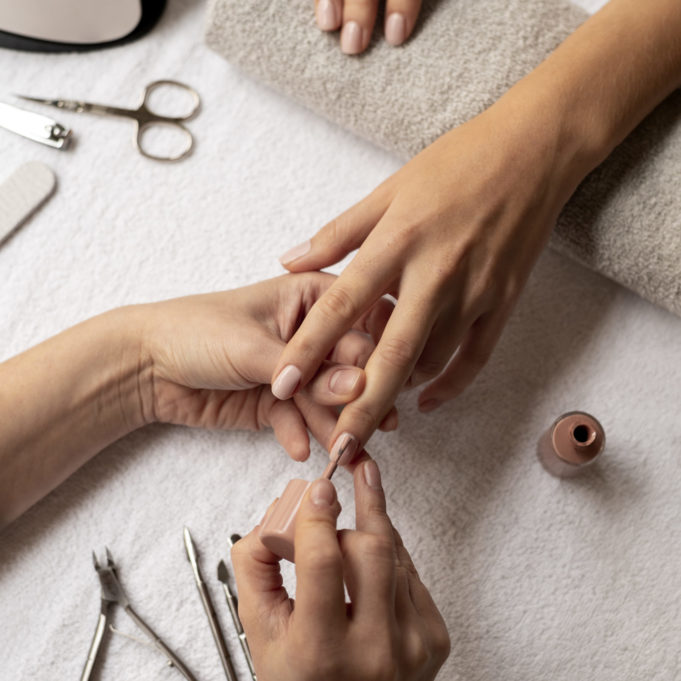 close-up-manicurist-using-nail-polish close-up-manicurist-using-nail-polish
