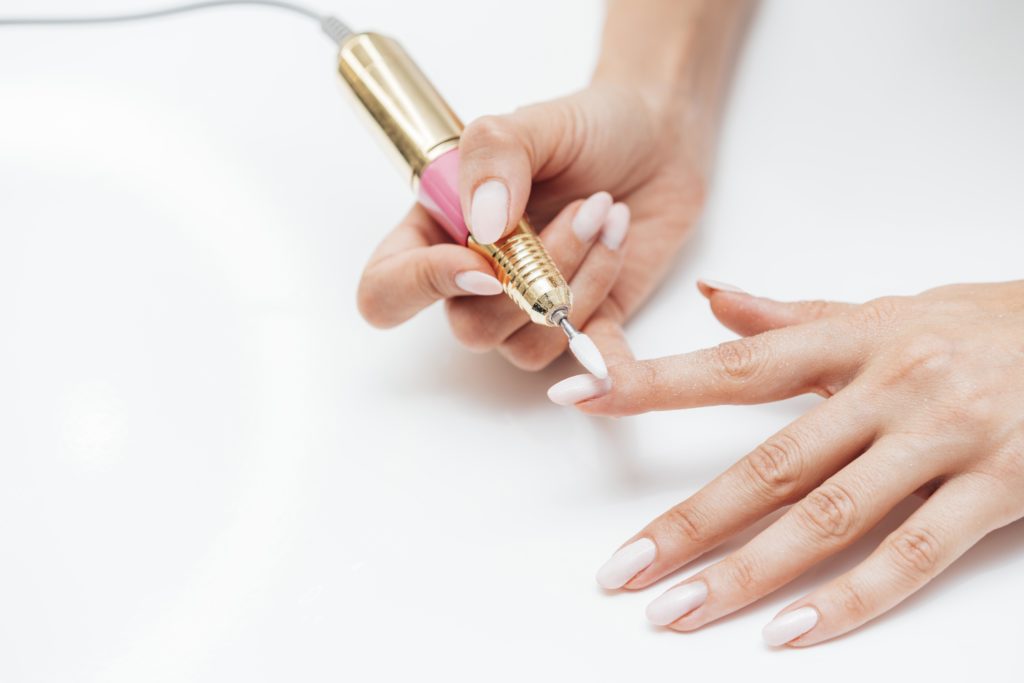 woman-using-digital-nail-file-high-view